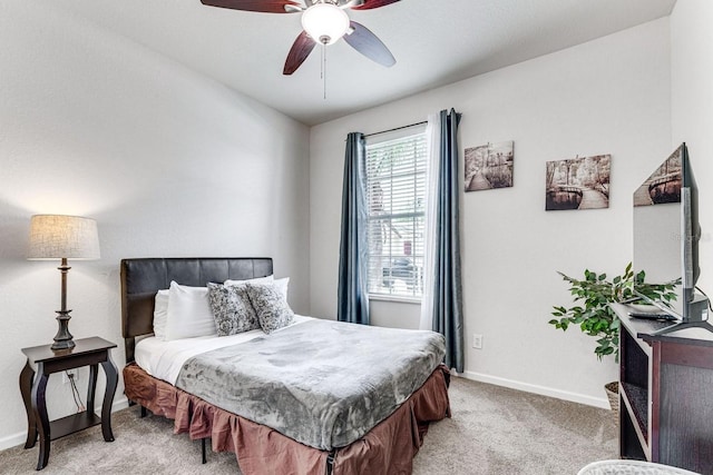 bedroom featuring light colored carpet and ceiling fan