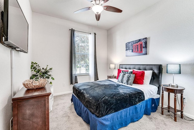 bedroom with light colored carpet and ceiling fan