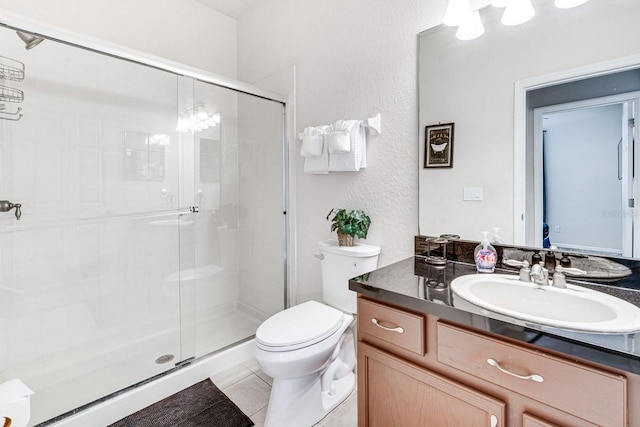 bathroom featuring tile patterned flooring, vanity, an enclosed shower, and toilet