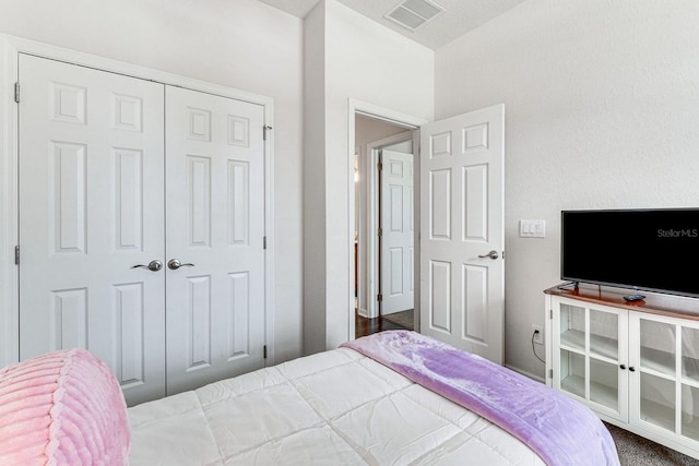 carpeted bedroom with a closet