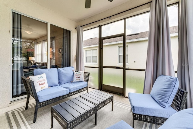 sunroom / solarium featuring a wealth of natural light and ceiling fan