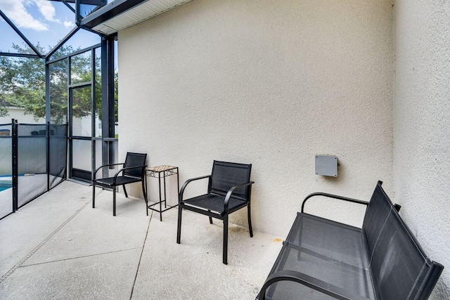 view of patio / terrace featuring glass enclosure