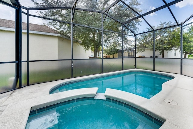 view of swimming pool featuring a lanai