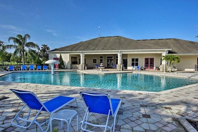 view of pool featuring a patio and french doors