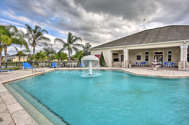 view of swimming pool with a patio and pool water feature