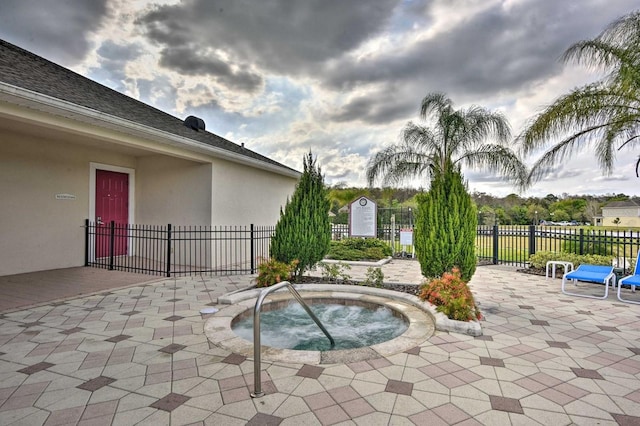 view of pool featuring a community hot tub and a patio area