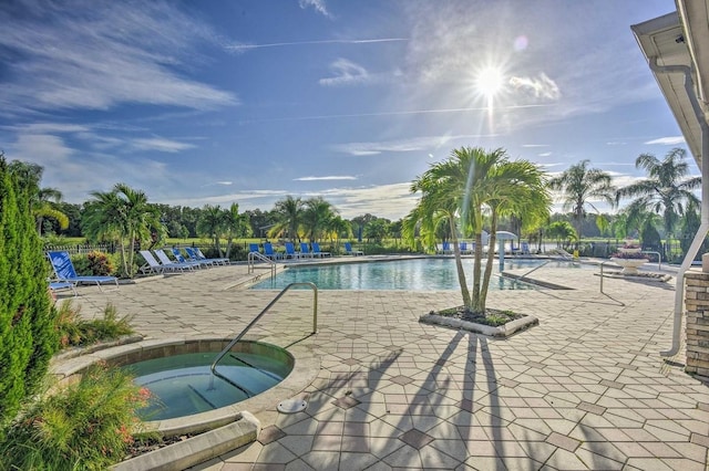 view of swimming pool with a community hot tub and a patio area