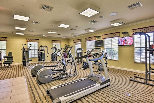 workout area featuring light colored carpet and ornamental molding