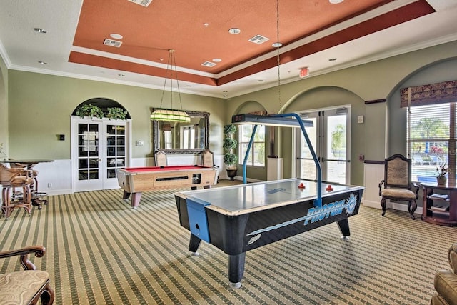 recreation room featuring french doors, light carpet, and a tray ceiling