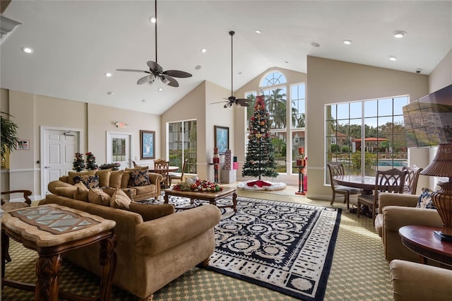 carpeted living room with a towering ceiling and ceiling fan