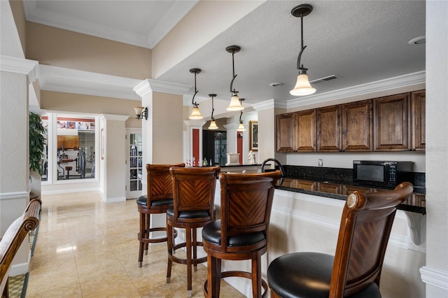 bar featuring decorative light fixtures, ornamental molding, and a textured ceiling