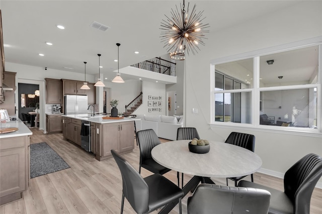 4360 Sunset Preserve Blvd, Orlando, FL 32820 - dining room featuring sink, light hardwood / wood-style floors, and an inviting chandelier