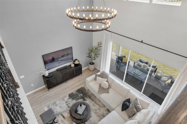 4360 Sunset Preserve Blvd, Orlando, FL 32820 - living room with light hardwood / wood-style flooring and an inviting chandelier