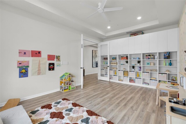 4360 Sunset Preserve Blvd, Orlando, FL 32820 - playroom featuring a tray ceiling, light hardwood / wood-style flooring, and ceiling fan