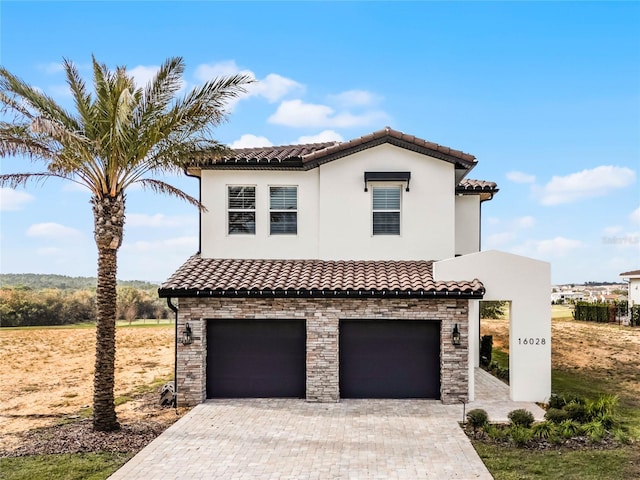 mediterranean / spanish house featuring a garage