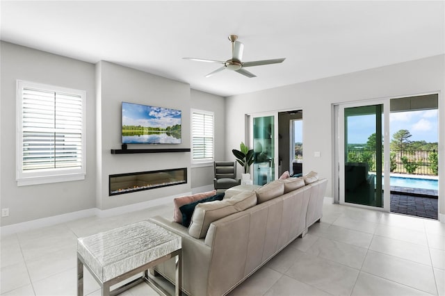 living room with ceiling fan and light tile patterned floors