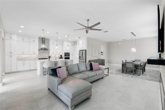 living room featuring ceiling fan and sink