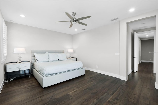 bedroom with dark hardwood / wood-style flooring and ceiling fan