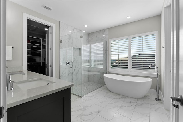 bathroom featuring vanity and separate shower and tub