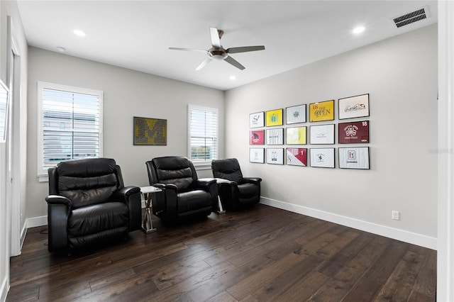 cinema room featuring dark hardwood / wood-style floors and ceiling fan