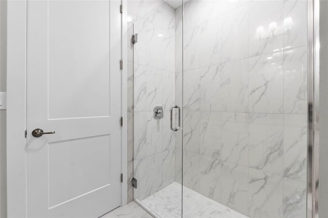 bathroom featuring a shower with door