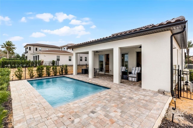 view of swimming pool with ceiling fan and a patio