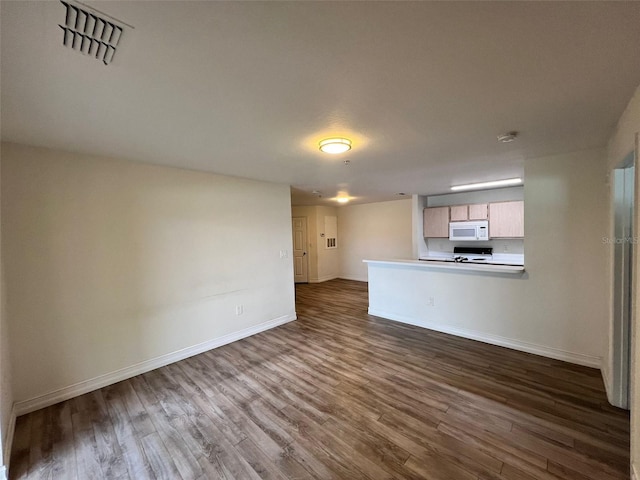 unfurnished living room with dark hardwood / wood-style floors