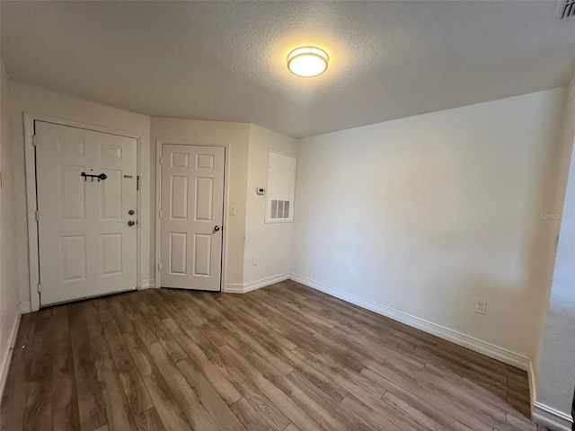 entryway featuring wood-type flooring and a textured ceiling