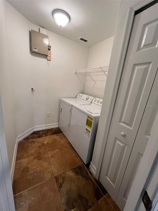 laundry area featuring separate washer and dryer and a textured ceiling