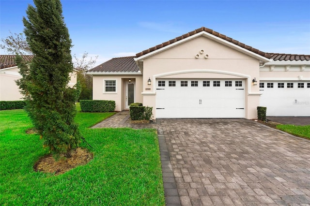 view of front of house featuring a garage and a front lawn