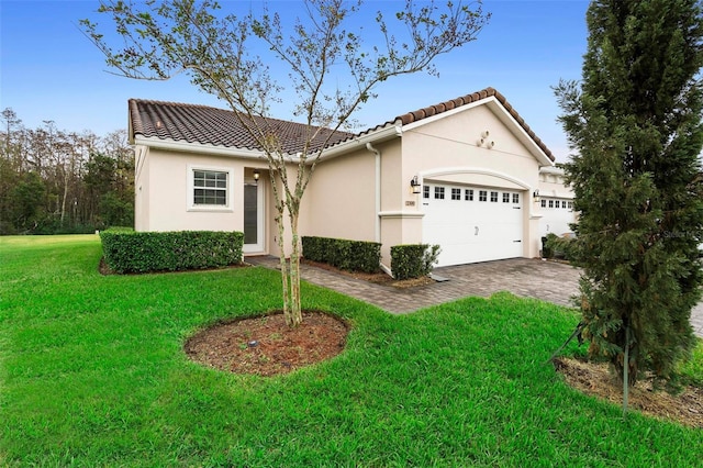 view of front of property featuring a garage and a front lawn