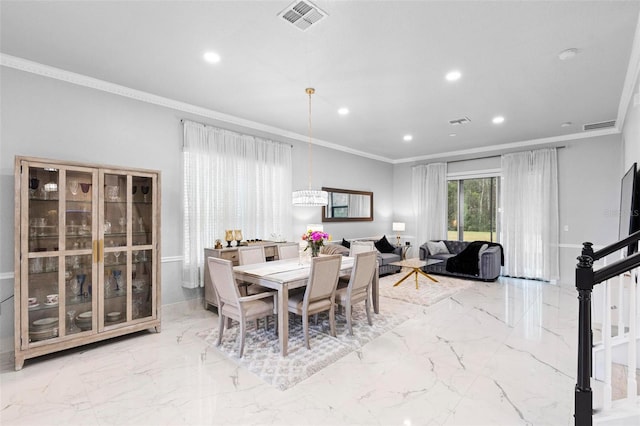 dining room featuring crown molding