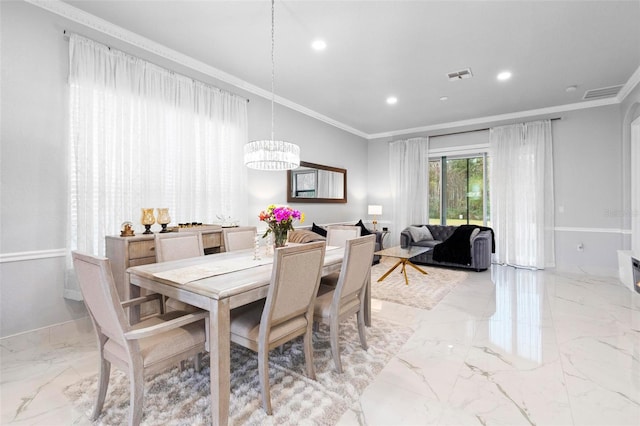 dining room with a notable chandelier and ornamental molding