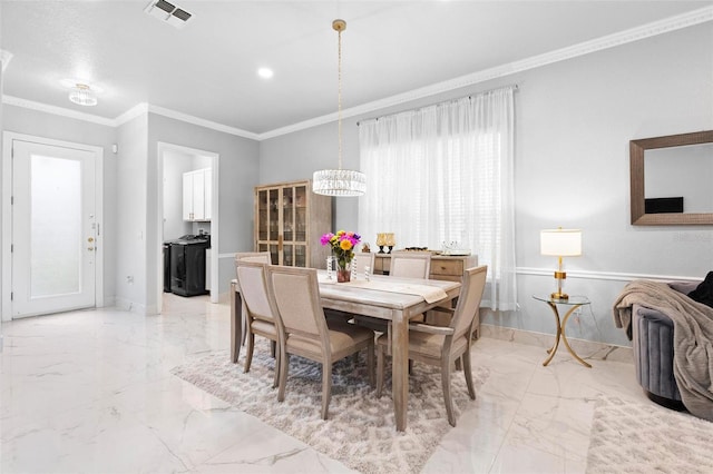 dining room featuring an inviting chandelier and ornamental molding