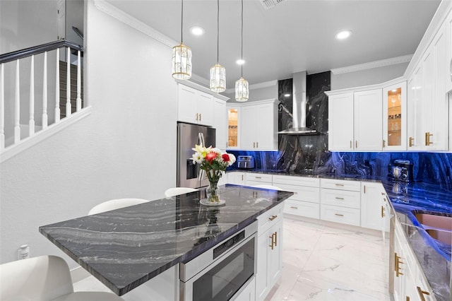 kitchen with white cabinets, wall chimney exhaust hood, stainless steel fridge, built in microwave, and tasteful backsplash