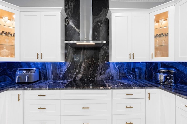 kitchen featuring white cabinets, tasteful backsplash, and wall chimney exhaust hood