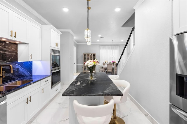 kitchen featuring white cabinetry, sink, ornamental molding, and stainless steel appliances