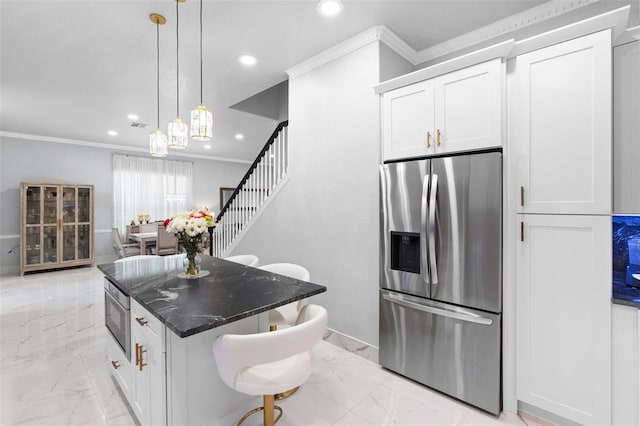 kitchen featuring stainless steel fridge with ice dispenser, a center island, white cabinets, and ornamental molding