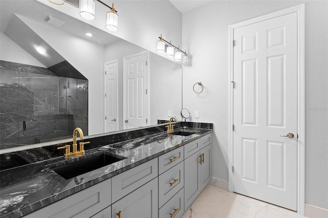 bathroom featuring a shower and vanity