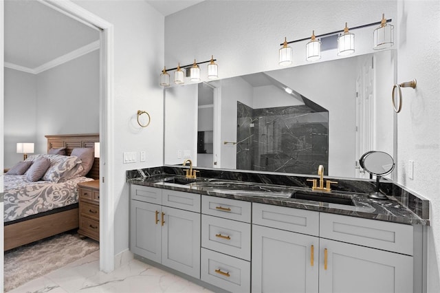 bathroom with vanity, ornamental molding, and tiled shower