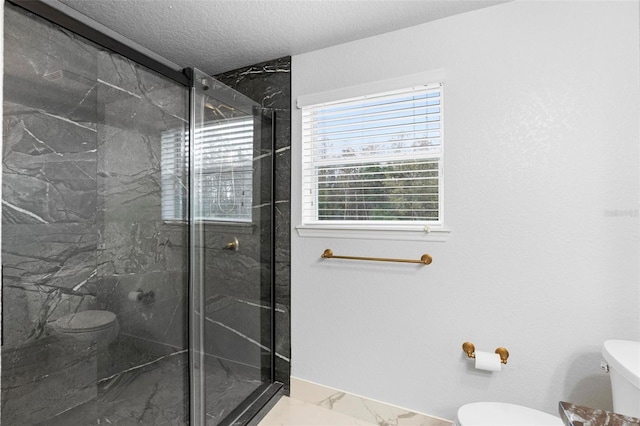 bathroom with a textured ceiling, toilet, and walk in shower