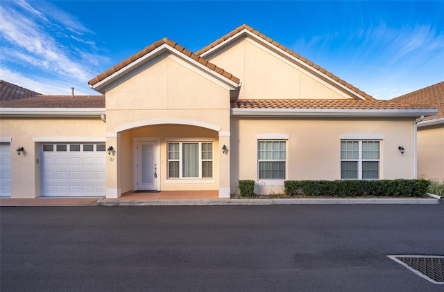 mediterranean / spanish-style house with a garage