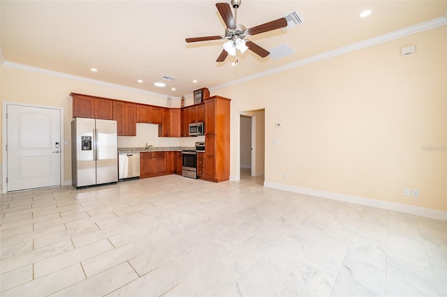 kitchen with ceiling fan, sink, ornamental molding, and appliances with stainless steel finishes