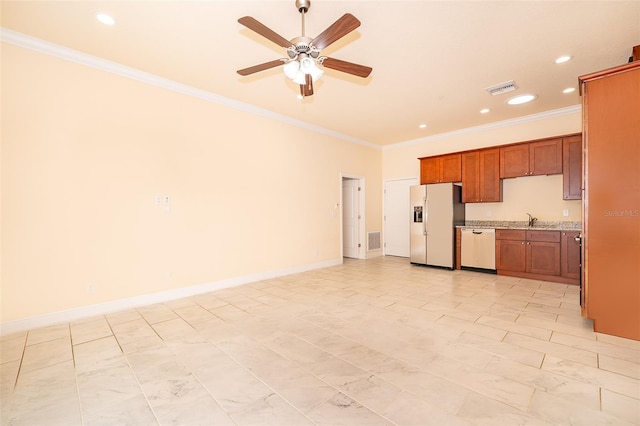 kitchen featuring appliances with stainless steel finishes, ceiling fan, crown molding, and sink