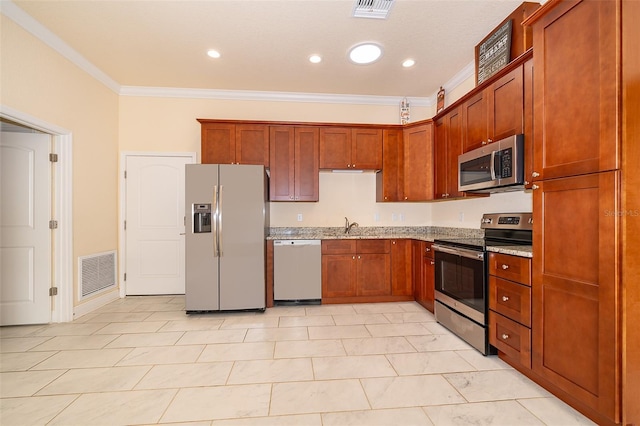 kitchen with light stone countertops, ornamental molding, sink, and appliances with stainless steel finishes