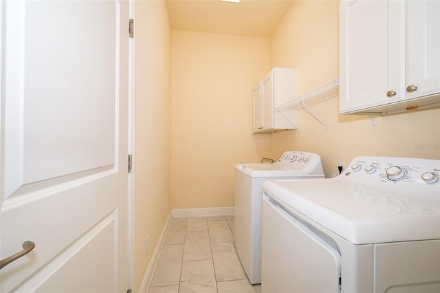 washroom with cabinets and separate washer and dryer