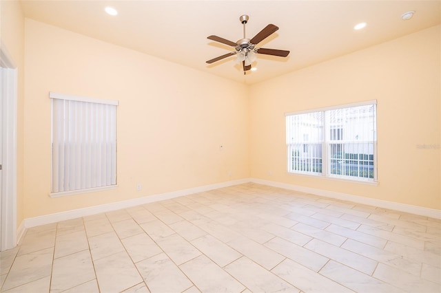 tiled spare room with ceiling fan