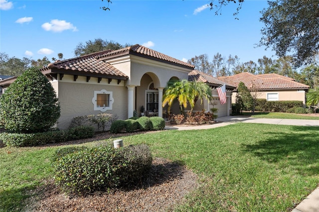 mediterranean / spanish home with a front yard