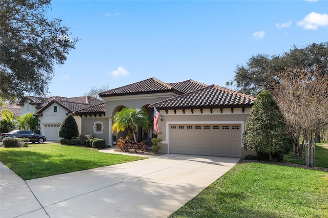 mediterranean / spanish home with a front yard and a garage