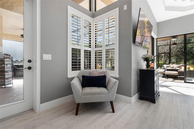 living area featuring plenty of natural light and light hardwood / wood-style floors